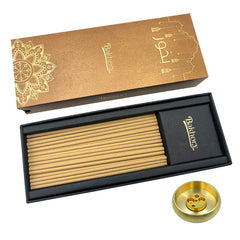 A set of Bakhory Oud incense sticks in a black box with gold accents, accompanied by a brass incense burner.